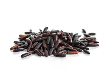 A bunch of unpolished black rice grains isolated on white background. Selective focus.  .