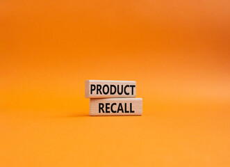 Product recall symbol. Concept words Product recall on wooden blocks. Beautiful orange background. Business and Product recall concept. Copy space.