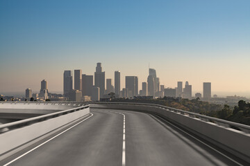 Fototapeta premium Empty urban asphalt road exterior with city buildings background. New modern highway concrete construction. Concept of way to success. Transportation logistic industry fast delivery. Los Angeles. USA.