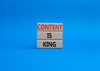Content is king symbol. Concept words Content is king on wooden blocks. Beautiful blue background. Business and Content is king concept. Copy space.
