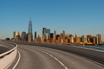 Empty urban asphalt road exterior with city buildings background. New modern highway concrete construction. Concept of way to success. Transportation logistic industry fast delivery. New York. USA.