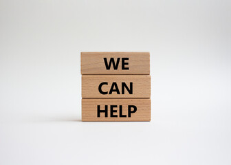 We can help symbol. Wooden blocks with words We can help. Beautiful white background. Business and We can help concept. Copy space.