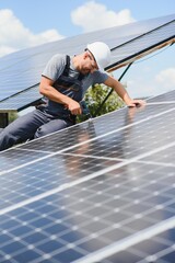 Worker installing solar panels outdoors