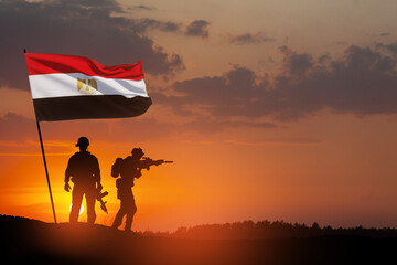 Silhouette Of Soliders Against the Sunrise in desert . Concept - armed forces of Egypt. Egypt celebration. Greeting card for Independence day, Memorial Day, Armed forces day, Sinai Liberation Day.