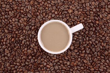 Cup of coffee and beans overhead shot