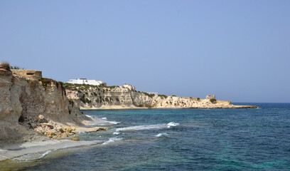 Fototapeta na wymiar coastline with yellow cliffs and small waves of the mediterranean sea