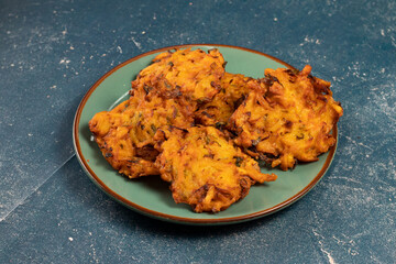 Indian spicy vegetable pakora or pakoda served in dish isolated on table top view