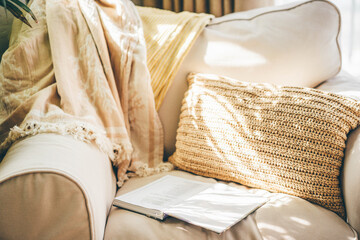 Open book on comfortable chair.