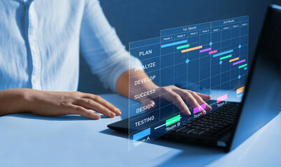 Business Project Management System. Project manager working on laptop and updating tasks and milestones progress planning with Gantt chart scheduling interface for company on virtual screen. 