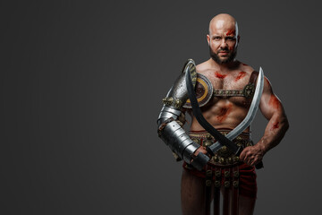 Portrait of powerful gladiator from past with naked torso and muscular build.