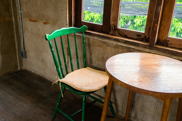 Green chair and table in restaurant.