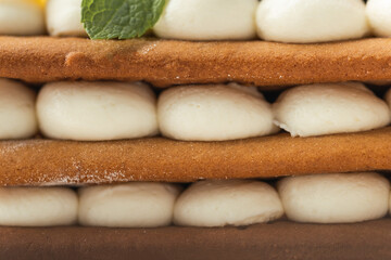 Birthday layered cake with cream cheese filling decorated with berries on white background. Macro shot