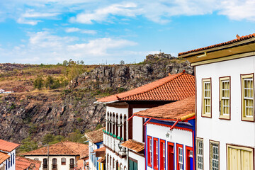 View of colonial style houses facade and mountains in the background on Diamantina city, Minas...