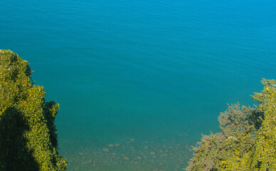 View from above on blue colorful bright black sea, coastline and green bushes as summer subtropical sunny landscape in Batumi botanical garden