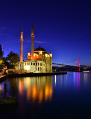 Fototapeta na wymiar ORTAKOY, ISTANBUL, TURKEY. Ortakoy Mosque and Bosphorus Bridge (15th July Martyrs Bridge) sunrise view.