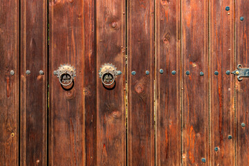 Fototapeta premium Old vintage wooden door ornate with a beauty metal furniture. Close up