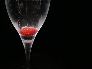 Delicious red gooseberry and bubbles in the glass