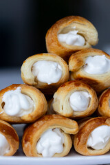 Homemade puff pastry cones stuffed with egg white cream