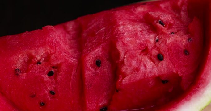 Cut red ripe and juicy watermelon into pieces, sliced red watermelon with pits into pieces in the kitchen