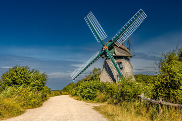 Path leading to windmill Charlotte am Geltinger, Birk, Baltic Sea, Germany. Bright blue sky.