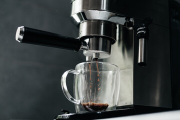 Coffee machine filling a cup with expresso. Transparent mug in automated coffeemaker machine. Beverage drink for breakfast