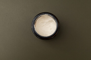 Jars and bottles of cosmetics on a dark background, the minimalism of the beauty industry
