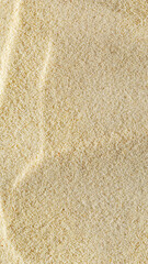 vertical sandy light background format 9:16 with waves of sand macro