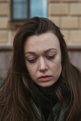 Fototapeta premium portrait of crying young woman on the street