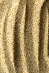 vertical sandy light background format 2:3 with waves of sand macro