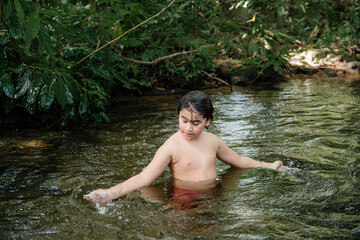 Boy playing in the water and having fun