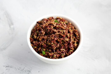 Homemade Mixed Olive Tapenade in a Bowl, side view.