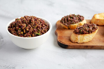 Homemade Mixed Olive Tapenade in a Bowl, side view.