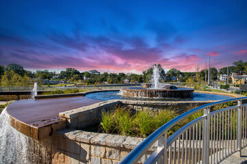 an autumn landscape at Rodney Cook Sr. Park in Historic Vine City with a circular stone water...
