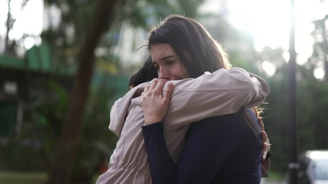 Person hugging friend during DIFFICULT times. Two women embrace and EMPATHY. Friendship concept