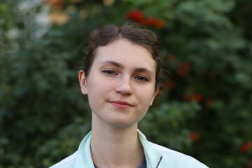 portrait of a cute girl on a background of trees