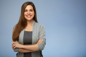 Smiling business woman standing with arms crossed.