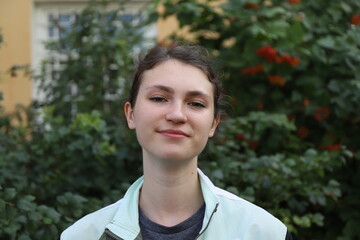 portrait of a cute girl on a background of trees