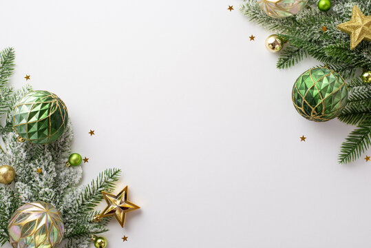 Christmas decorations concept. Top view photo of pine branches in snow with gold green transparent baubles star ornaments and shiny confetti on isolated white background with copyspace