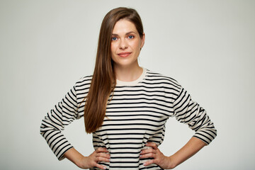 Smiling woman in striped shirt with hands on waist.