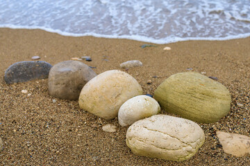 Fototapeta na wymiar Very beautiful background or backdrop of huge pebbles on the resort beach, selective focus with copy space