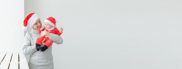 Banner fatherhood and holidays concept - Father with his baby boy wearing Santa hats celebrating Christmas