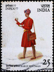 Early indian postman on vintage postage stamp