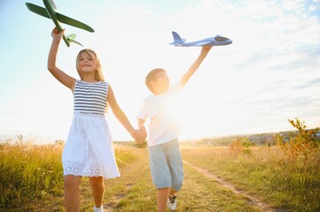 children play toy airplane. concept of happy childhood. children dream of flying and becoming a pilot.
