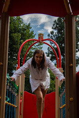 brunette woman in white shirt having fun on the playground