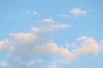 Blue sky background with white clouds at sunset