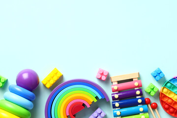 Colorful kids toys on pastel blue background. Educational baby toys top view. Flat lay.