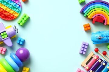 Flat lay baby toys. Top view colorful educational toys on pastel blue background.