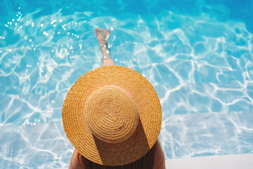 top view. a woman in a straw hat in the pool.