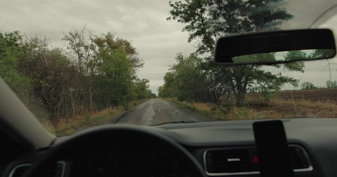 POV driving a car at the autumn countryside road