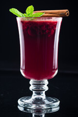 Summer raspberry tea with mint, cinnamon and spices in a glass. Cup of hot tea with raspberry